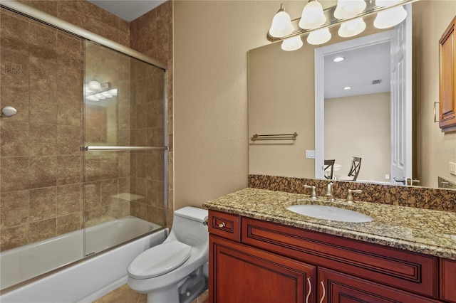 bathroom featuring visible vents, shower / bath combination with glass door, vanity, and toilet