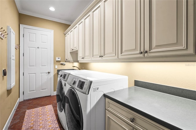 laundry room featuring cabinet space, baseboards, dark tile patterned flooring, crown molding, and separate washer and dryer