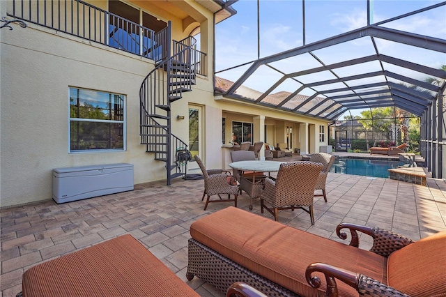 view of patio with glass enclosure, outdoor dining area, outdoor lounge area, stairs, and an outdoor pool