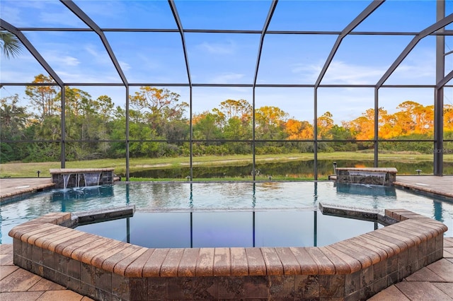 view of swimming pool featuring a pool with connected hot tub, a water view, and a lanai