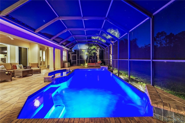 view of swimming pool with glass enclosure, a pool with connected hot tub, a patio area, and an outdoor hangout area