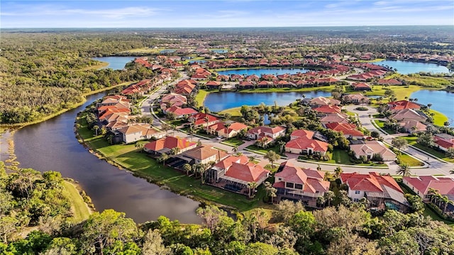 drone / aerial view featuring a residential view and a water view