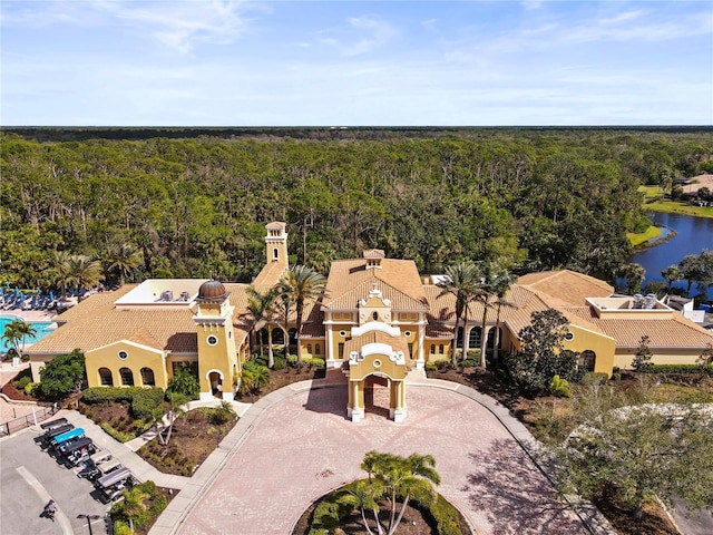 aerial view featuring a water view and a wooded view