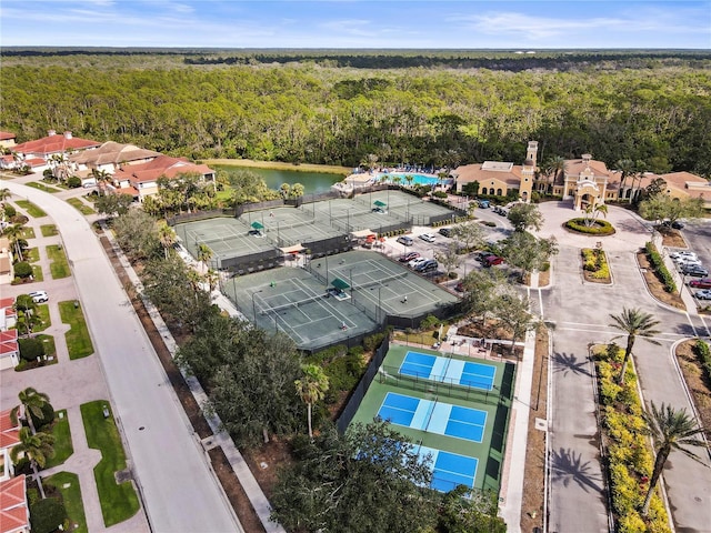 birds eye view of property featuring a water view and a forest view