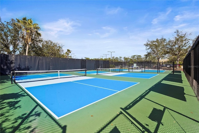 view of sport court featuring fence