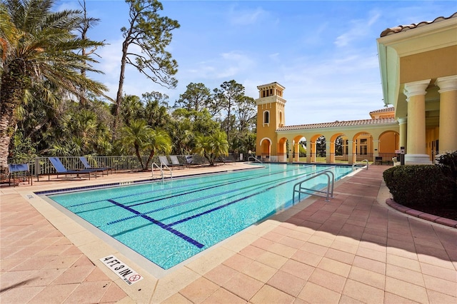 pool featuring a patio area and fence