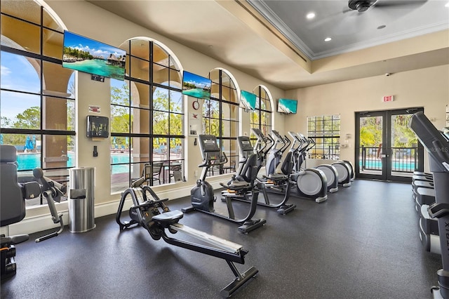 workout area featuring french doors, recessed lighting, a raised ceiling, ornamental molding, and baseboards