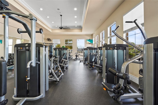 workout area with a ceiling fan, ornamental molding, a tray ceiling, and recessed lighting