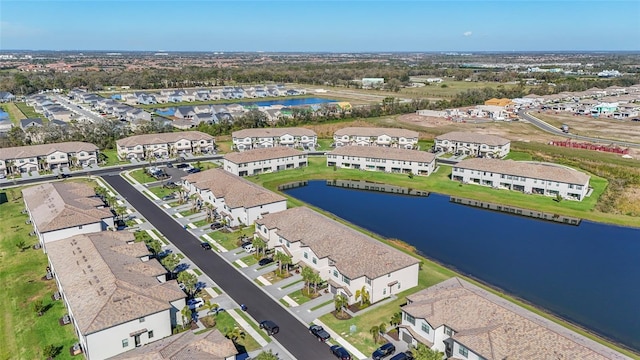 drone / aerial view with a water view and a residential view