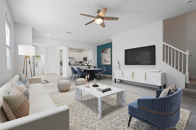 living area with visible vents, ceiling fan, recessed lighting, and stairs