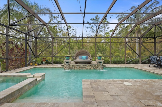 view of pool featuring a lanai, a pool with connected hot tub, and a patio