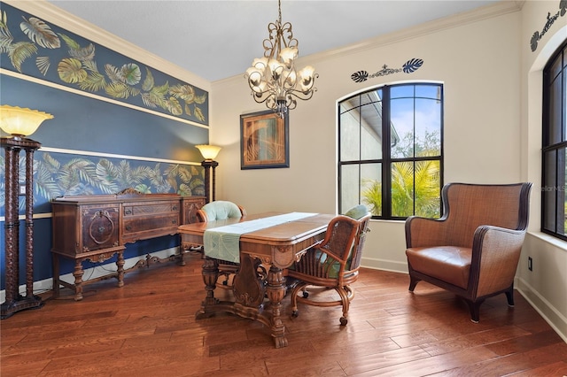 dining space with baseboards, a chandelier, crown molding, and wood finished floors