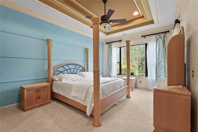 bedroom with crown molding, a raised ceiling, light colored carpet, ceiling fan, and baseboards