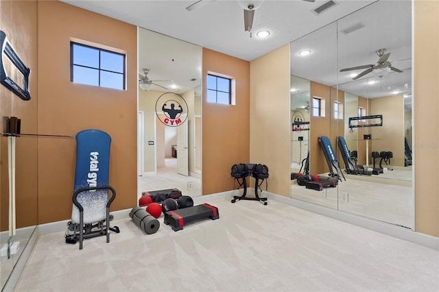 workout room with carpet, visible vents, and a ceiling fan