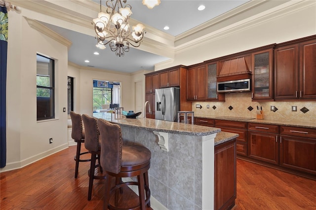 kitchen with appliances with stainless steel finishes, backsplash, and dark wood finished floors