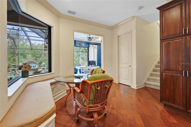 living area featuring visible vents, baseboards, stairway, wood finished floors, and crown molding