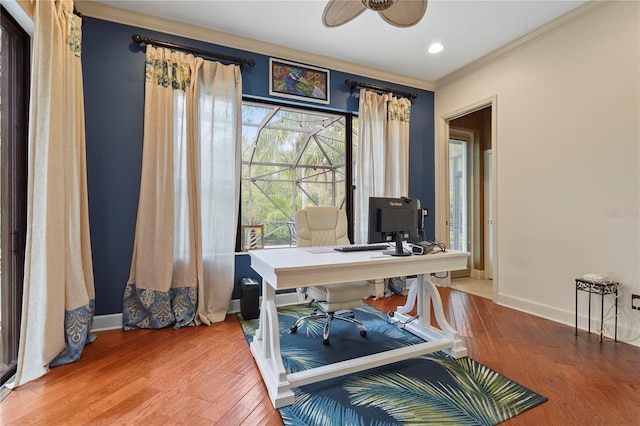 office featuring ornamental molding, ceiling fan, baseboards, and wood finished floors