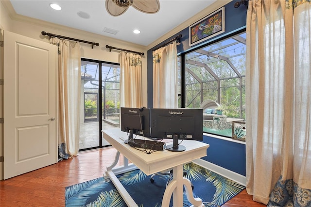 home office with recessed lighting, visible vents, a sunroom, hardwood / wood-style floors, and crown molding