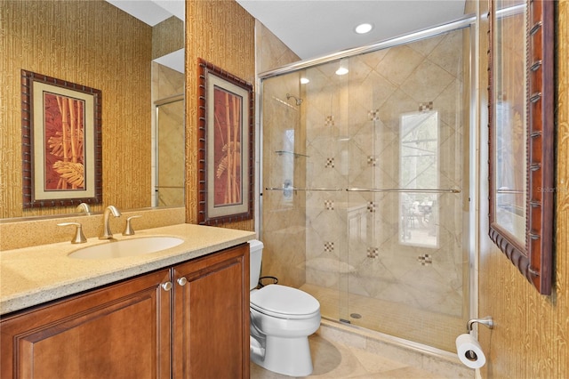 full bathroom with a shower stall, toilet, and vanity