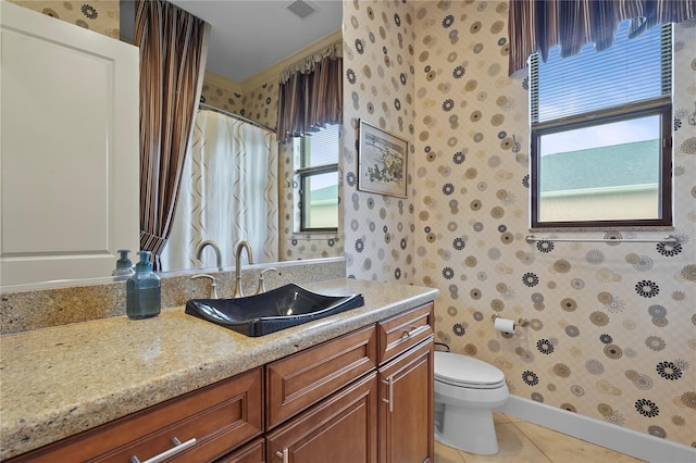 bathroom featuring toilet, wallpapered walls, visible vents, and tile patterned floors