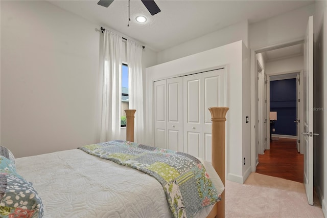 bedroom with carpet floors, a closet, baseboards, and a ceiling fan