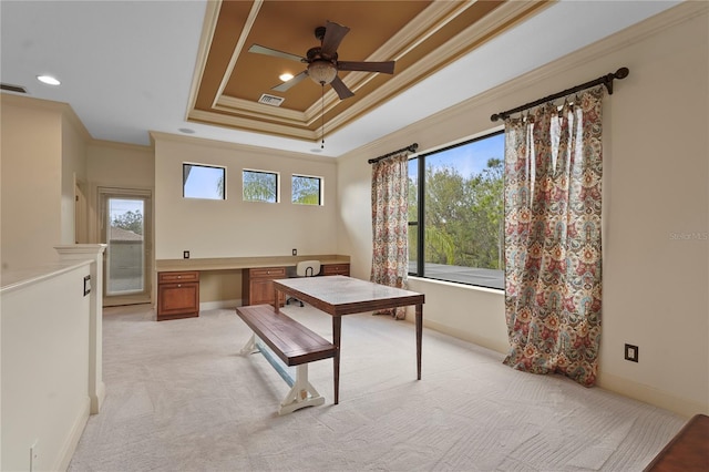 office area with light carpet, crown molding, baseboards, and built in study area