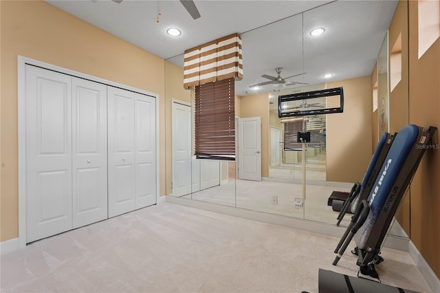 exercise room with carpet, ceiling fan, a textured ceiling, and recessed lighting