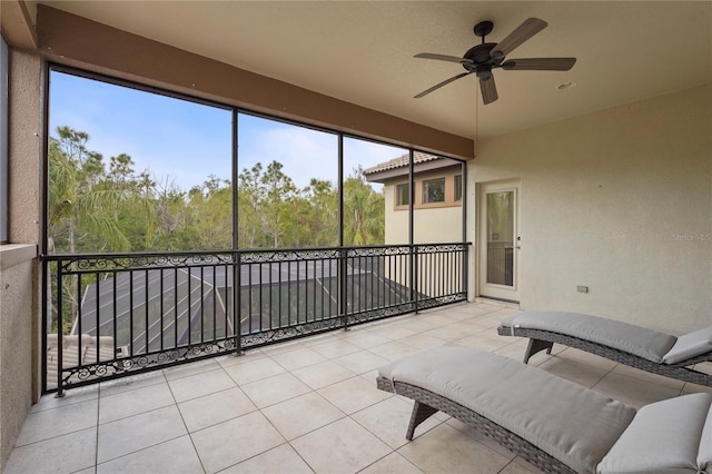 unfurnished sunroom with a ceiling fan