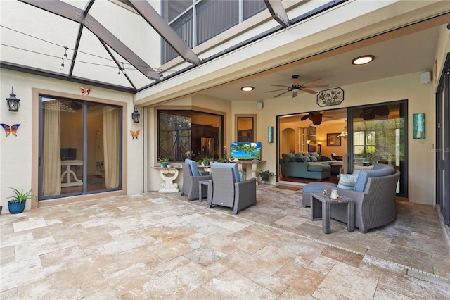 view of patio featuring a lanai, an outdoor living space, and a ceiling fan