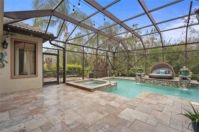 view of swimming pool with a patio, glass enclosure, and a pool with connected hot tub