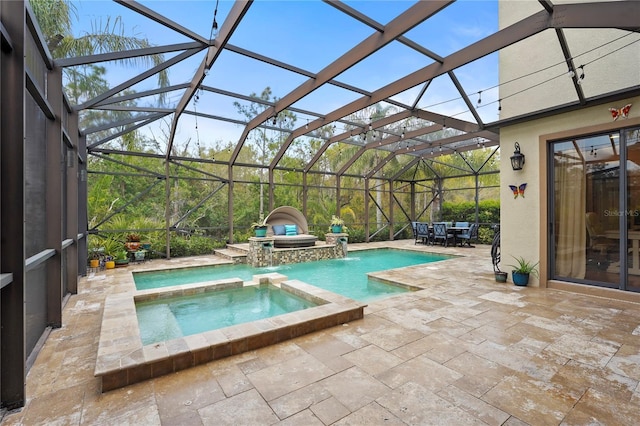 view of pool with a lanai, a pool with connected hot tub, and a patio