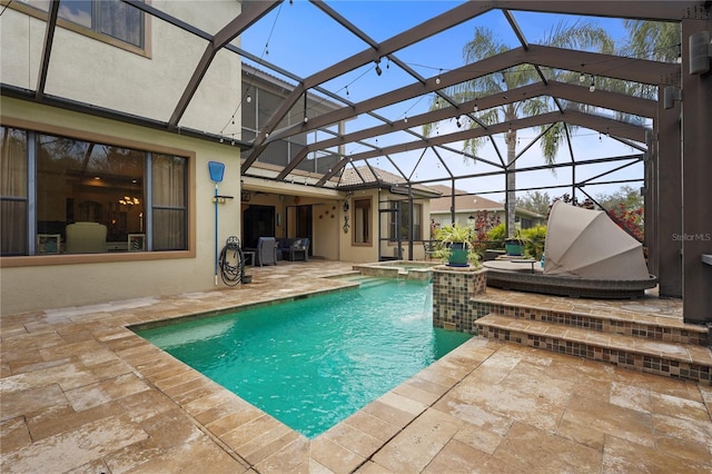 view of swimming pool with a lanai, a pool with connected hot tub, and a patio