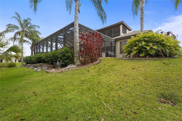 exterior space featuring a yard and a lanai