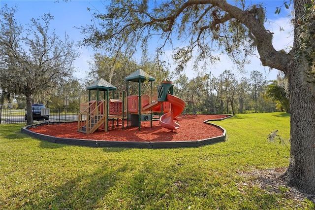 community jungle gym with fence and a yard