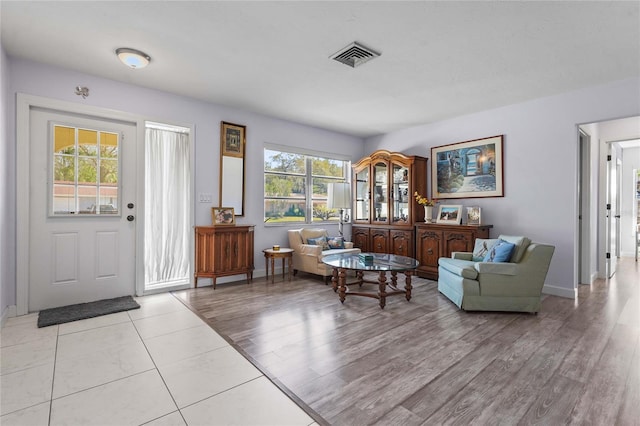 entrance foyer featuring baseboards, visible vents, and light wood finished floors