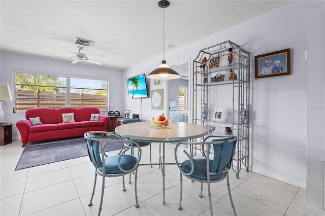 dining area featuring tile patterned floors, visible vents, baseboards, and a ceiling fan