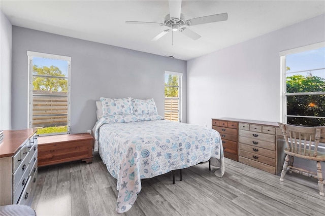 bedroom with a ceiling fan and wood finished floors