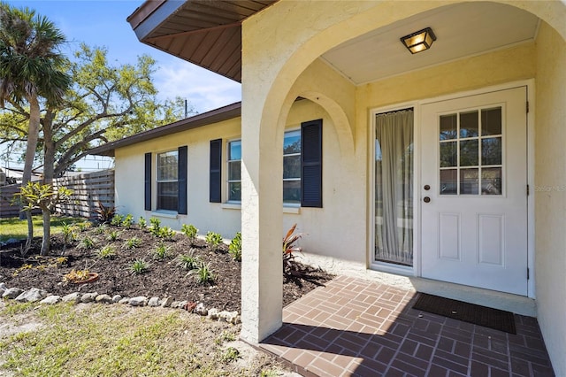 view of exterior entry featuring stucco siding