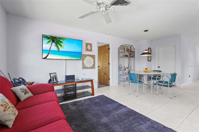 living room with tile patterned flooring, baseboards, and a ceiling fan