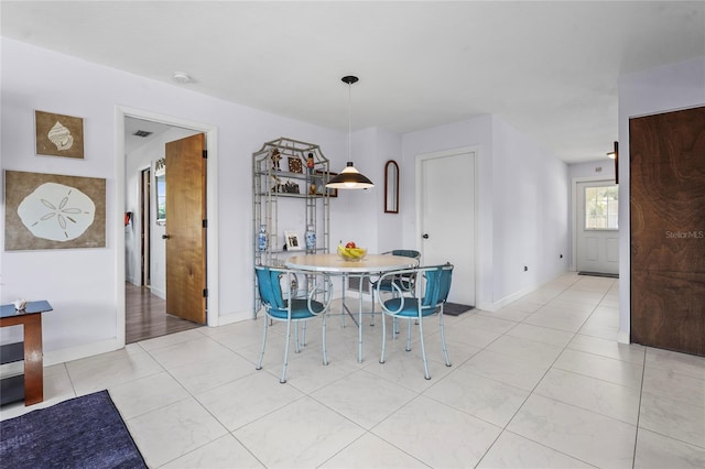 dining space with light tile patterned floors, visible vents, and baseboards