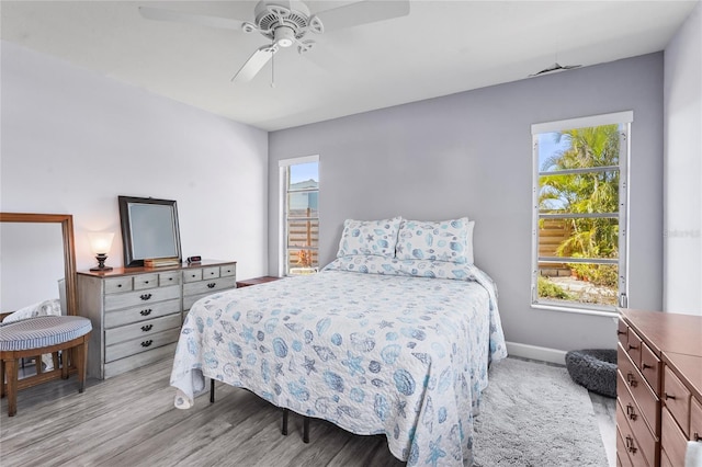 bedroom with baseboards, a ceiling fan, and wood finished floors