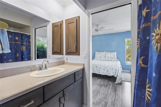 full bathroom featuring vanity, ensuite bathroom, ceiling fan, and wood finished floors