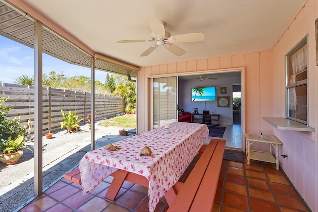 sunroom with a wealth of natural light and ceiling fan