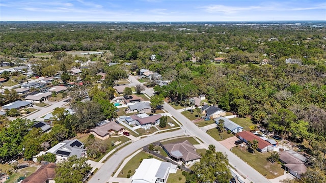 drone / aerial view with a residential view and a view of trees