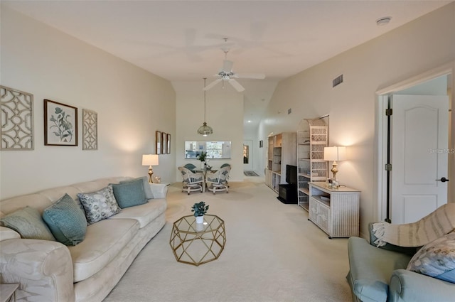 living room featuring light carpet, ceiling fan, high vaulted ceiling, and visible vents