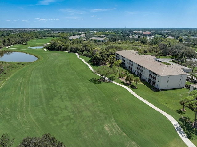 drone / aerial view featuring view of golf course and a water view