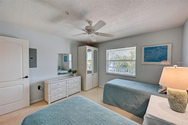 bedroom featuring electric panel, baseboards, light colored carpet, ceiling fan, and a textured ceiling