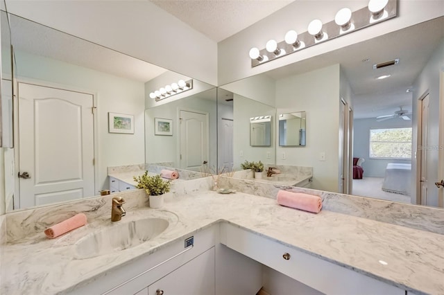 full bath with a ceiling fan, visible vents, vanity, and a textured ceiling