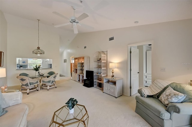 living room featuring high vaulted ceiling, carpet, visible vents, and a ceiling fan