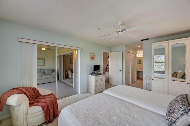 bedroom featuring access to exterior, ceiling fan, multiple closets, and light colored carpet